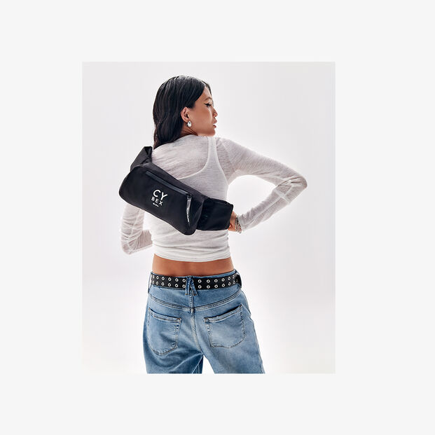 A woman with a black Belt Bag on her back.