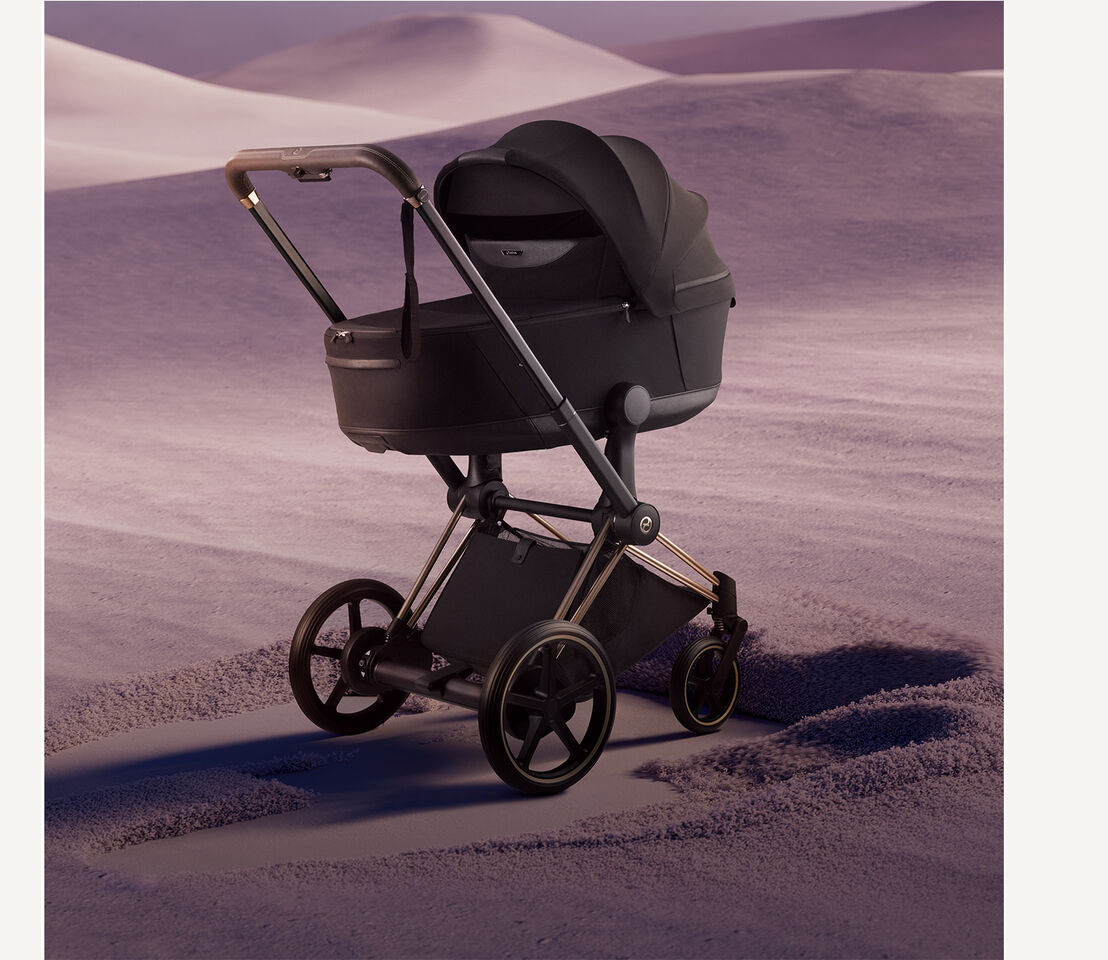 An e-Priam standing on sand.