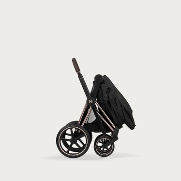 An image of the CYBEX Platinum Priam Fold Lux Carry Cot - Style Collection Stroller, highlighting the Folds Compact on Frame feature.