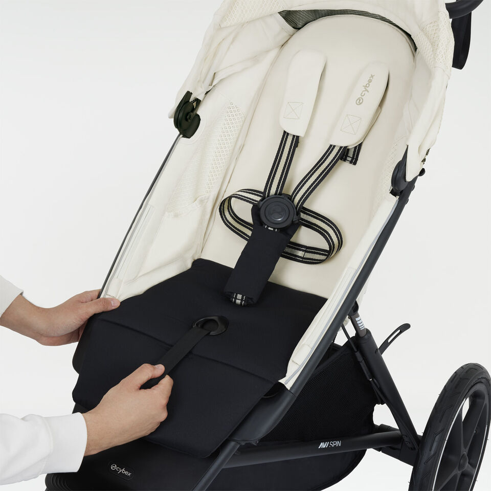 Close-up of a one-pull harness of the Avi Spin stroller.