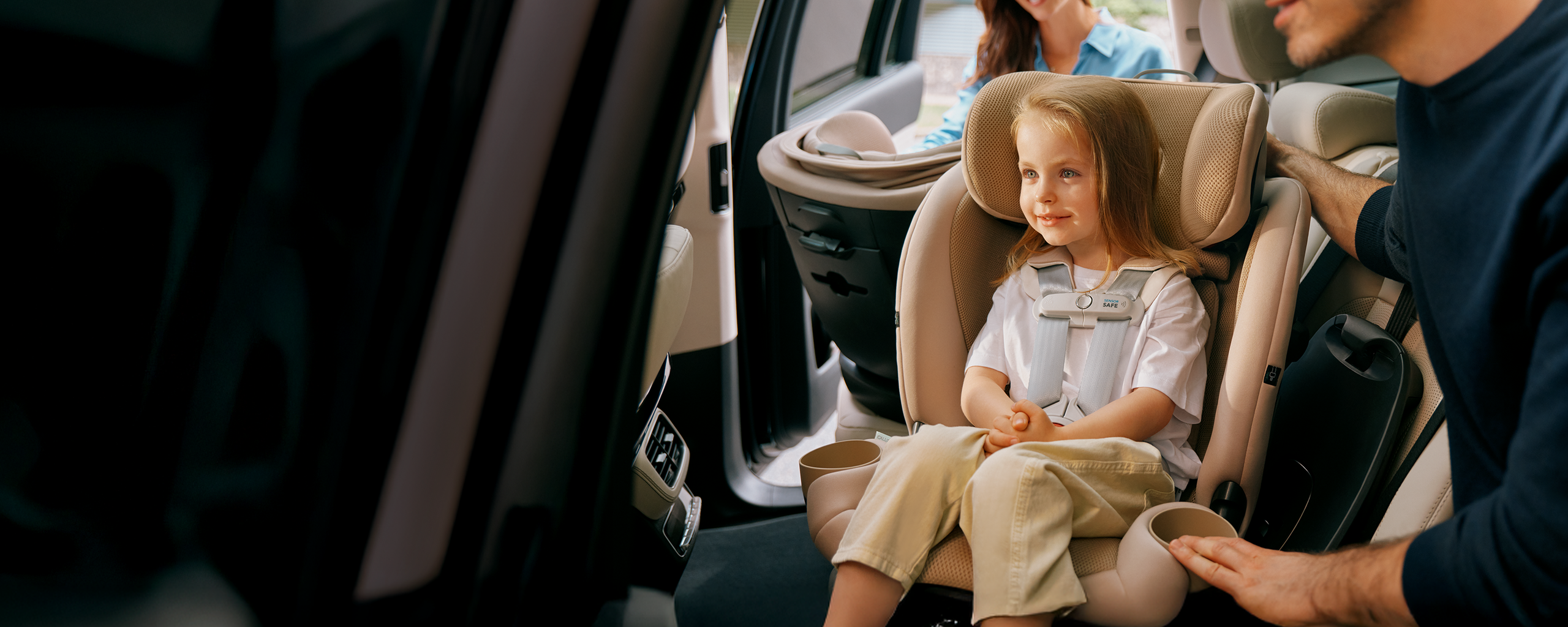 A child is sitting in a car seat, another car seat behind her. The text on the asset reads "SensorSafe. Same. Smart. Connected" with two buttons for download, one in the App Store, one in the Google Play store.