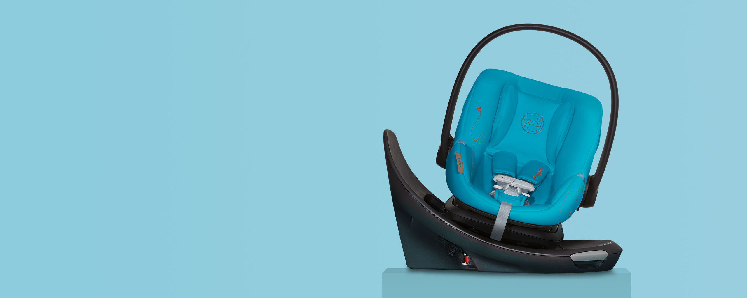 A blue Aton G car seat on a black base against a light blue background.