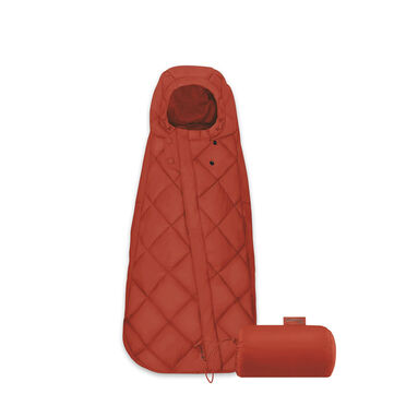 A red sleeping bag with a hood and matching stuff sack.