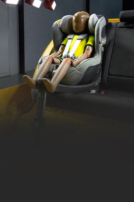 A crash test dummy sitting inside a CYBEX car seat in a test vehicle.