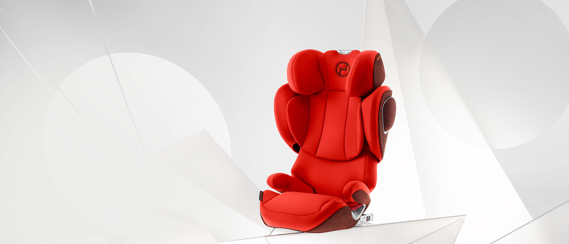 Red Solution Z booster car seat against a white background.