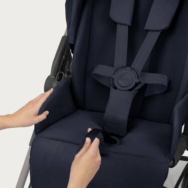 An image of the CYBEX Gold Melio Stroller, highlighting the One-pull Harness feature.