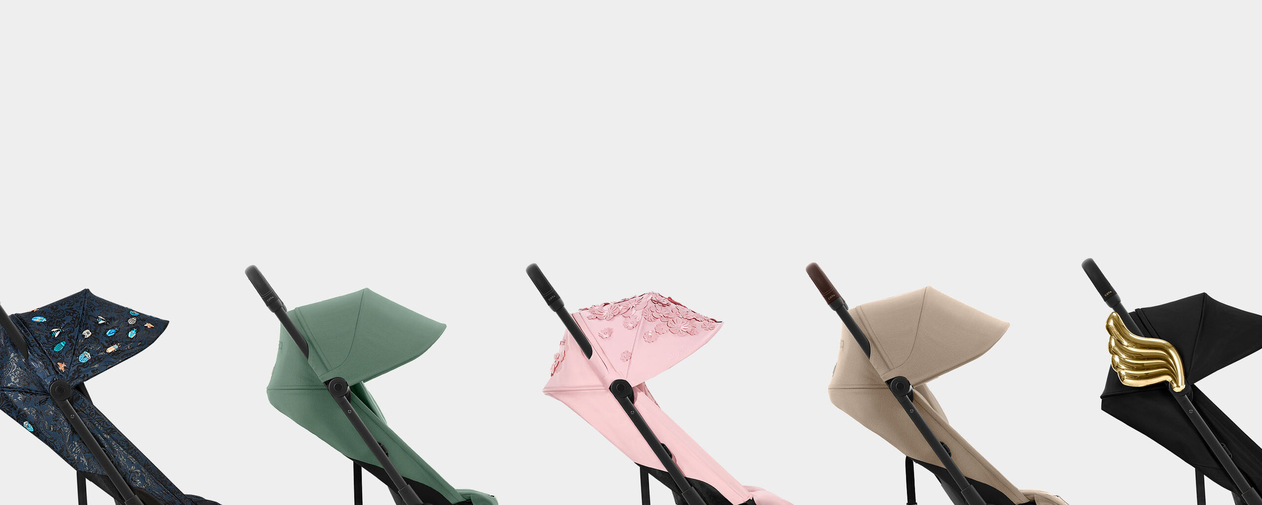 Five Coya compact travel strollers in different colours and designs side by side.