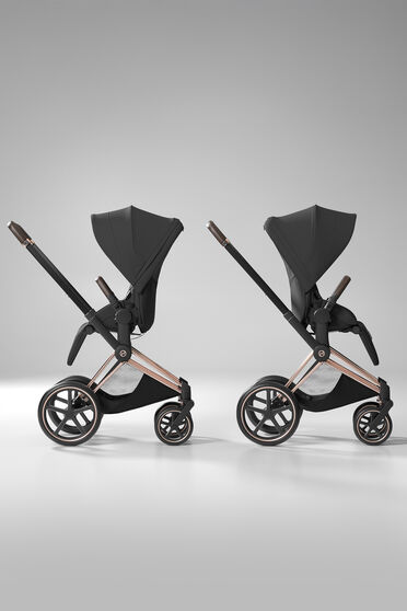 Two Priam strollers with seat units, one with a forward-facing position, one with a parent-facing one.