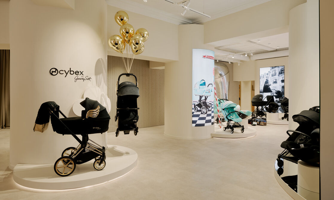 CYBEX Jeremy Scott on display. There's a stroller hanging by golden balloons, signaling it's part of the Wings collection.