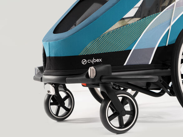A blue Cybex pram with modern patterns and sturdy wheels.