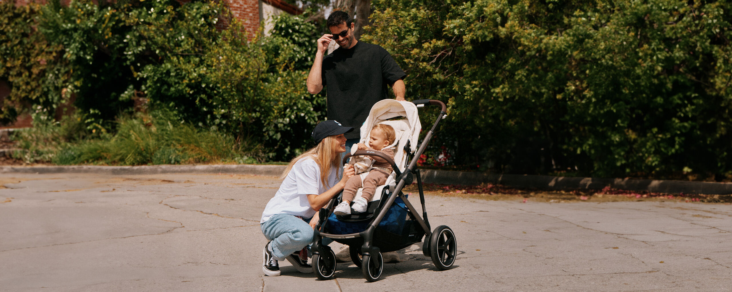 Man and woman with pram outdoors.