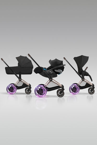 Three e-Priam strollers with a Fold Lux Carry Cot, infant car seat and seat pack.