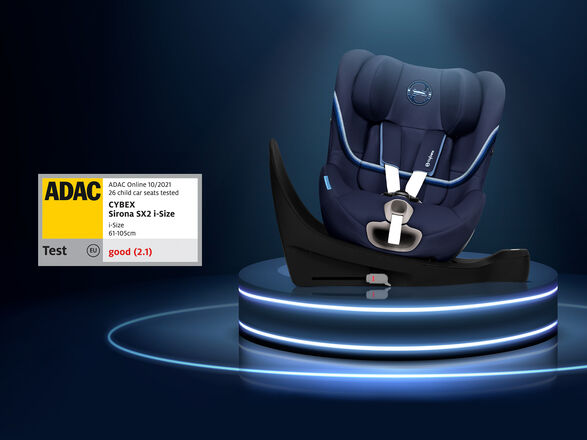 A dark blue Cybex Sirona SX2 i-Size child car seat on an illuminated platform, showing an ADAC test rating of "good" (2.1).
