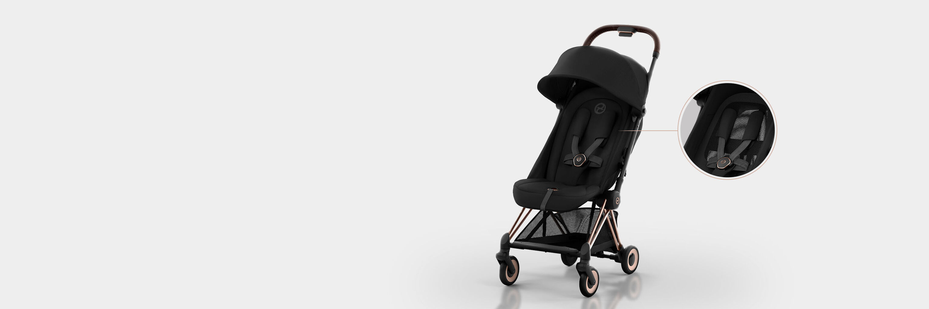 Black Coya compact travel stroller on a white background.