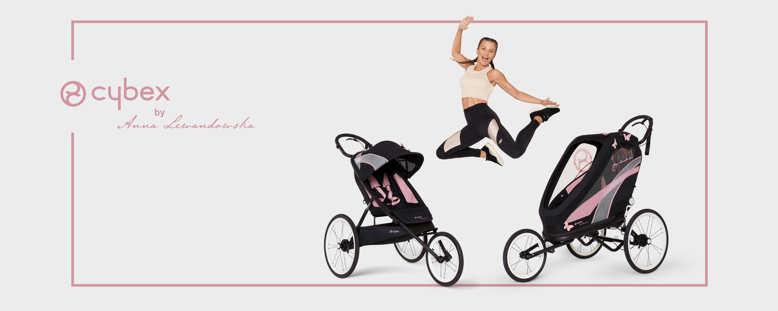 A woman jumps in athletic wear between two Cybex pushchairs.