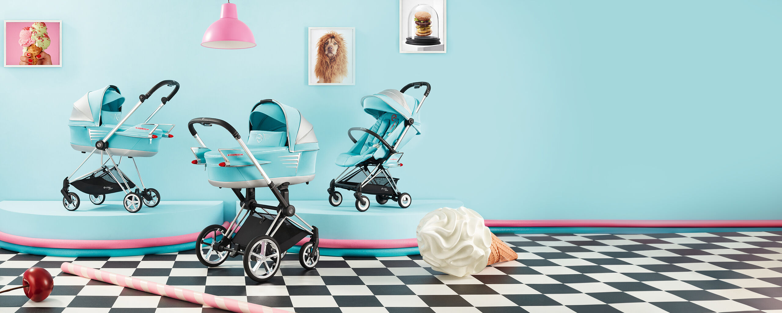 by Jeremy Scott Wings strollers in a pastel blue room with ice cream cone and cherry decorations.