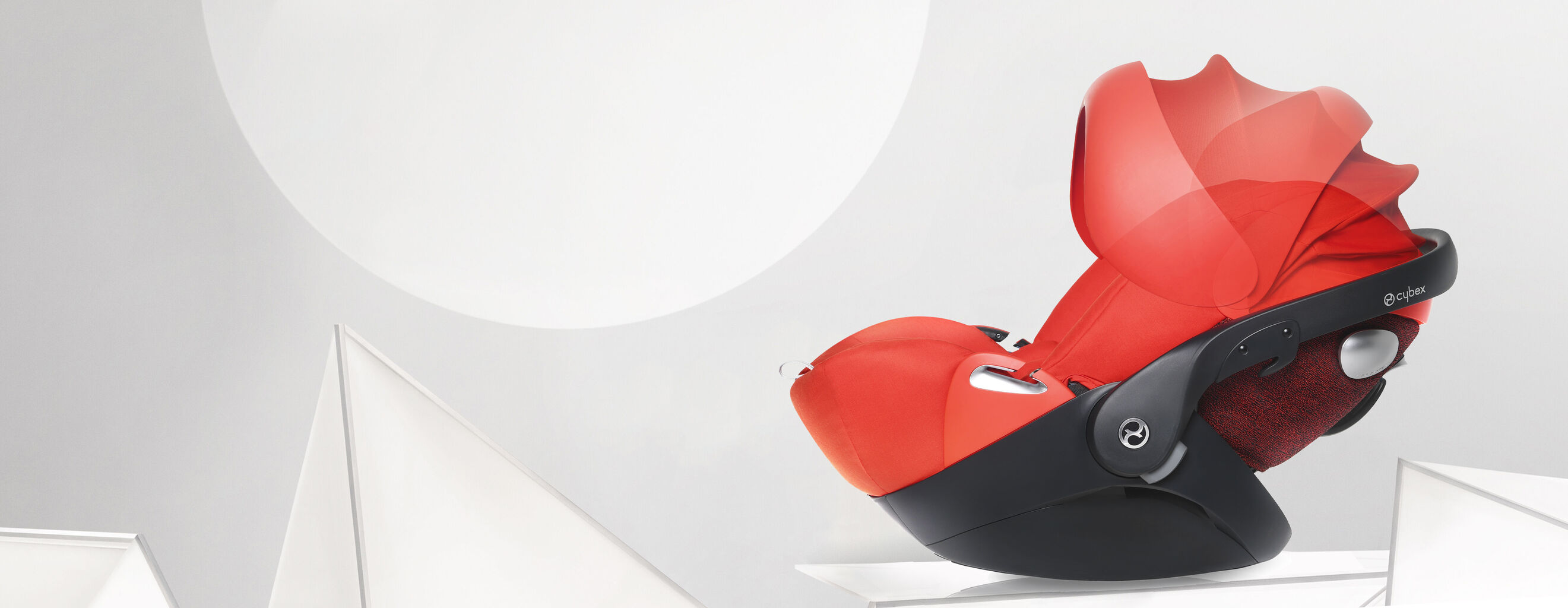 Red Cloud Q designer infant car seat with a modern design against a minimalist background.