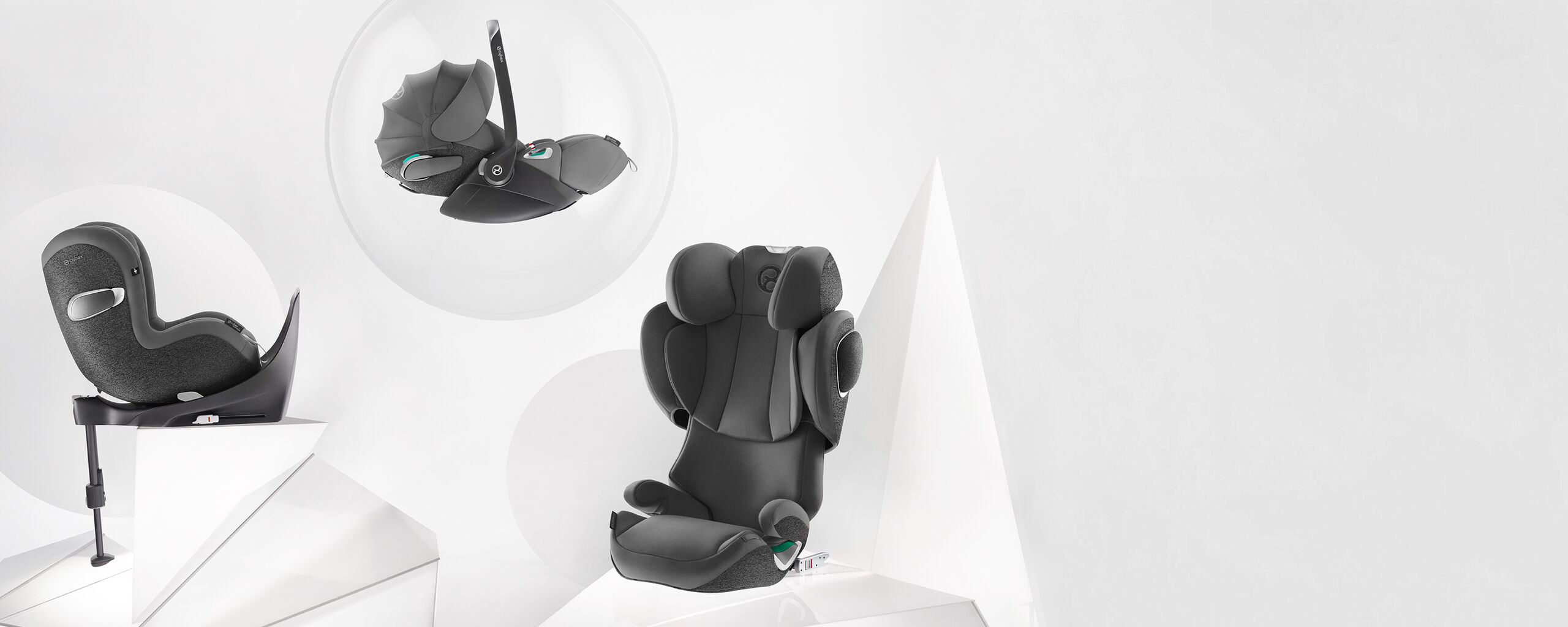 A grey child car seat shown from different angles on a white background.