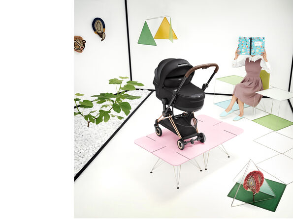 A CYBEX Coya buggy with a foldable cot attached.